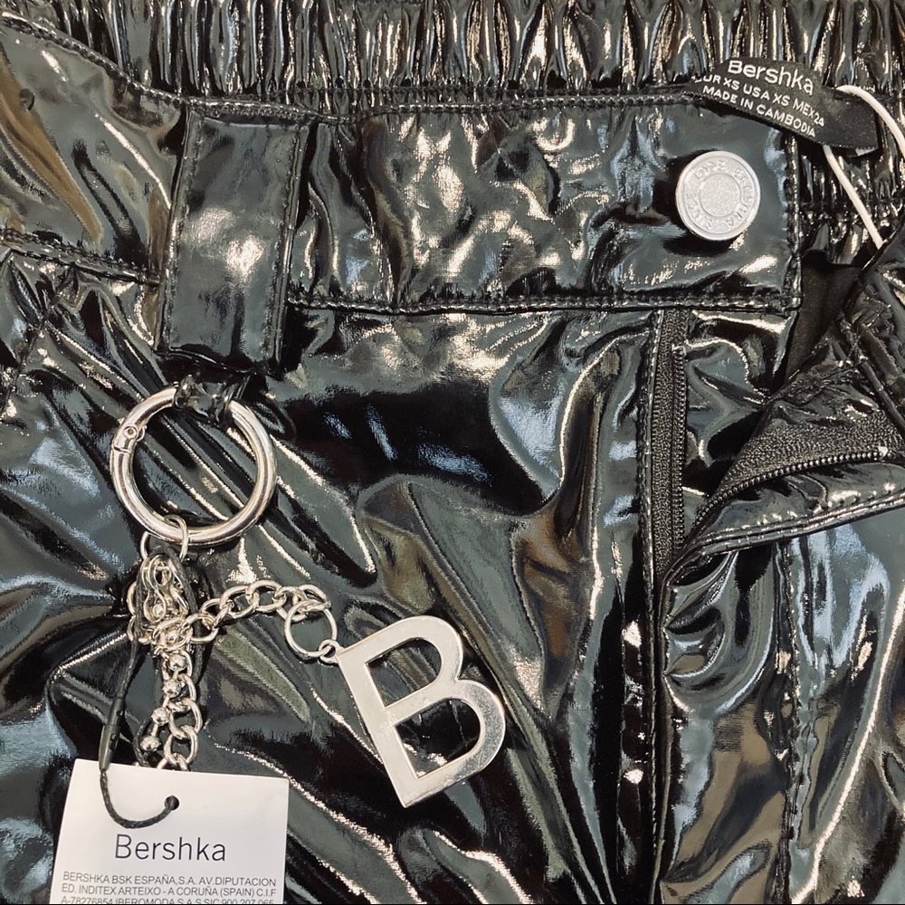 Black faux leather pants with chain